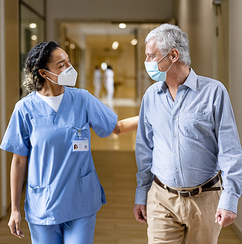 Doctor talking to a patient in the corridor of a hospital